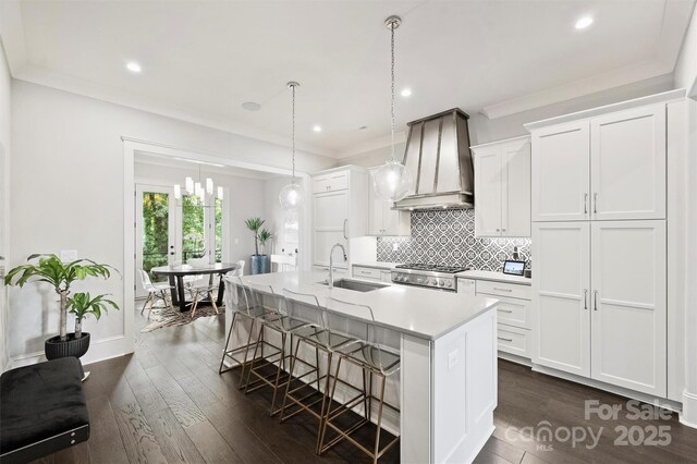 622 Mattie Rose Ln, Charlotte, NC 28204 - kitchen with custom range hood, a kitchen island with sink, a kitchen bar, light countertops, and white cabinets