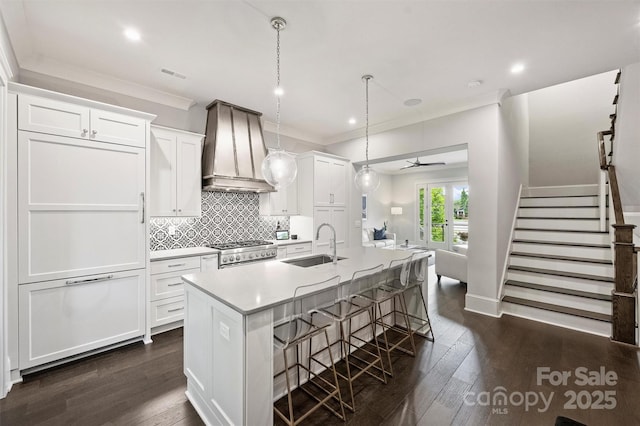 622 Mattie Rose Ln, Charlotte, NC 28204 - kitchen featuring custom exhaust hood, white cabinets, range, dark wood finished floors, and ornamental molding