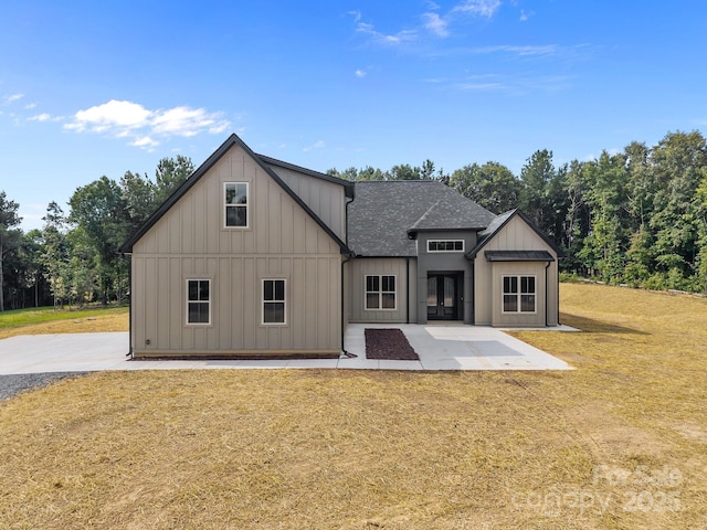5507 NC-218 Hwy, Peachland, NC 28133 - view of front facade featuring board and batten siding, a shingled roof, a front lawn, and a patio