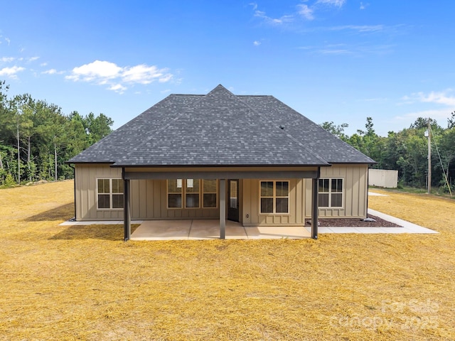 5507 NC-218 Hwy, Peachland, NC 28133 - rear view of house with roof with shingles, board and batten siding, a patio, and a lawn