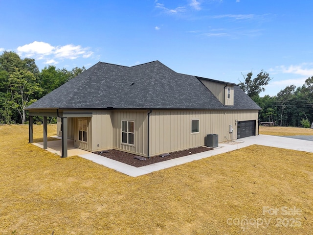 5507 NC-218 Hwy, Peachland, NC 28133 - back of property with driveway, a yard, a garage, and roof with shingles