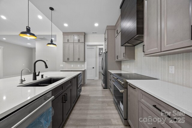 5507 NC-218 Hwy, Peachland, NC 28133 - kitchen featuring appliances with stainless steel finishes, wall chimney exhaust hood, light countertops, light wood-style flooring, and recessed lighting