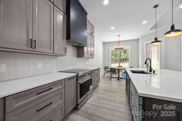 5507 NC-218 Hwy, Peachland, NC 28133 - kitchen with stainless steel range with electric cooktop, light wood-type flooring, light countertops, recessed lighting, and a chandelier