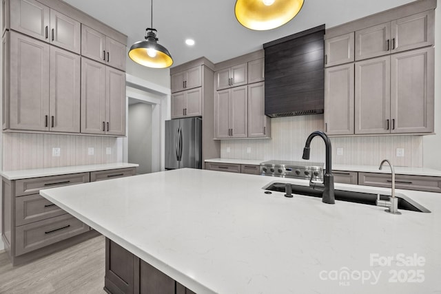 5507 NC-218 Hwy, Peachland, NC 28133 - kitchen featuring freestanding refrigerator, decorative light fixtures, custom exhaust hood, gray cabinets, and decorative backsplash