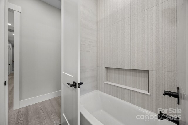 5507 NC-218 Hwy, Peachland, NC 28133 - bathroom with wood finished floors and washtub / shower combination