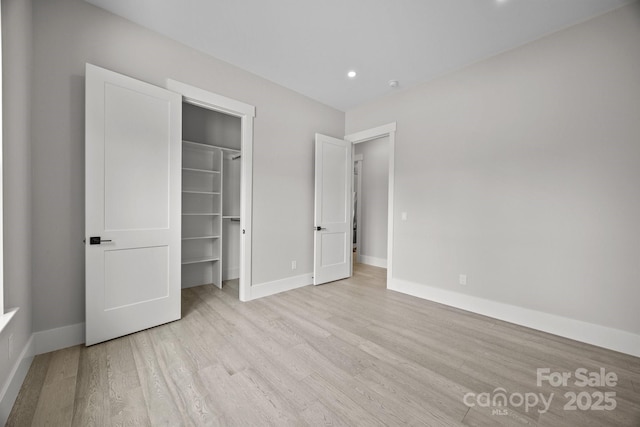 5507 NC-218 Hwy, Peachland, NC 28133 - unfurnished bedroom featuring light wood-style flooring, a spacious closet, recessed lighting, and a closet