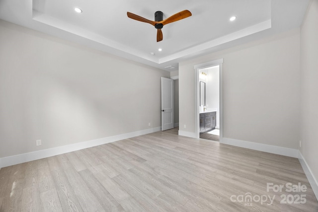 5507 NC-218 Hwy, Peachland, NC 28133 - unfurnished bedroom with a tray ceiling, light wood finished floors, recessed lighting, ensuite bath, and ceiling fan