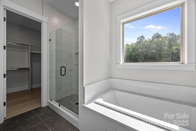 5507 NC-218 Hwy, Peachland, NC 28133 - bathroom with a stall shower, a bath, tile patterned flooring, and a walk in closet