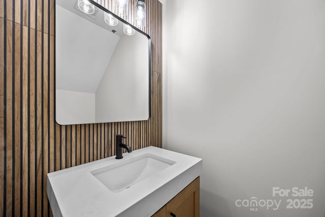 5507 NC-218 Hwy, Peachland, NC 28133 - bathroom featuring vanity, wallpapered walls, and vaulted ceiling