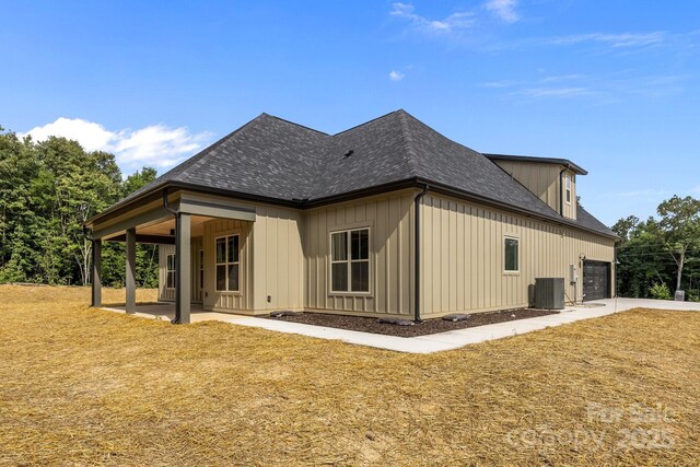 5507 NC-218 Hwy, Peachland, NC 28133 - back of house with a shingled roof, an attached garage, board and batten siding, and a patio area