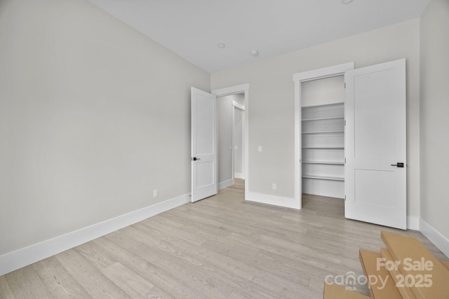 5507 NC-218 Hwy, Peachland, NC 28133 - unfurnished bedroom featuring light wood-style floors, a walk in closet, and a closet