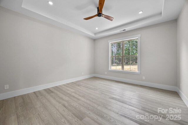 5507 NC-218 Hwy, Peachland, NC 28133 - unfurnished room featuring a tray ceiling, recessed lighting, light wood-style floors, and a ceiling fan