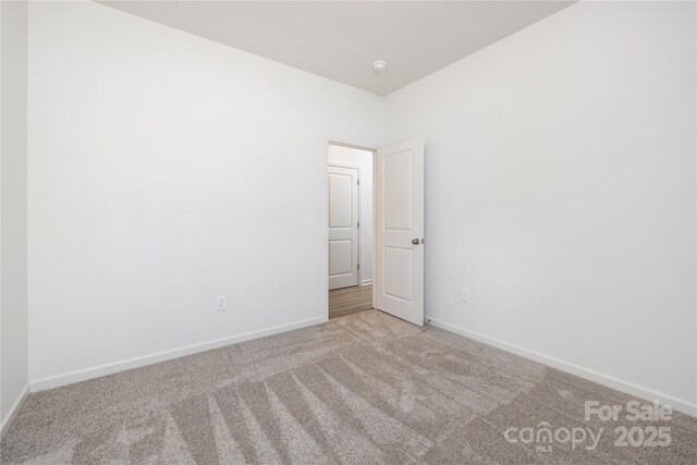 8 Bridge St, Lowell, NC 28098 - empty room featuring carpet, baseboards, and a smoke detector