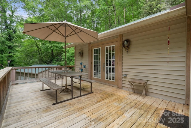 80 Laurel Canyon Rd, Franklin, NC 28734 - wooden terrace featuring outdoor dining space, french doors, and view of wooded area