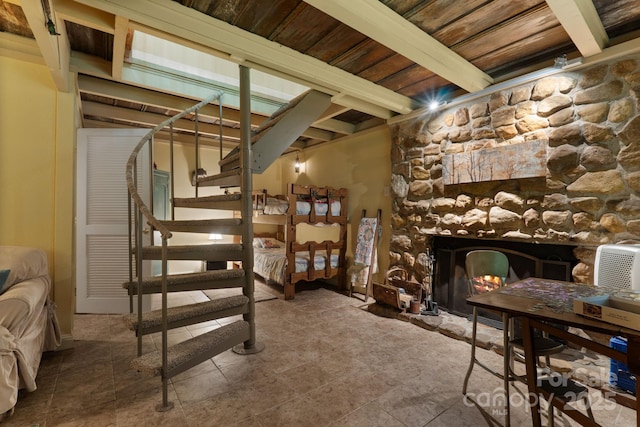 80 Laurel Canyon Rd, Franklin, NC 28734 - bedroom featuring a fireplace and a wooden ceiling with exposed beams