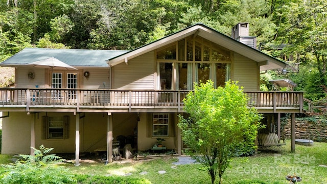80 Laurel Canyon Rd, Franklin, NC 28734 - rear view of house with a wooden deck, a metal roof, a chimney, and a view of trees