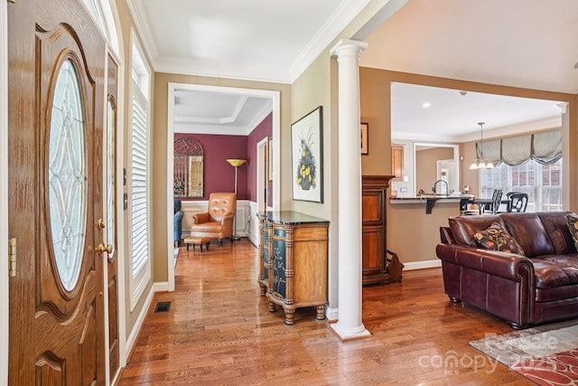 7612 Maple Bluff Ln, Concord, NC 28025 - foyer featuring wood finished floors, crown molding, and decorative columns