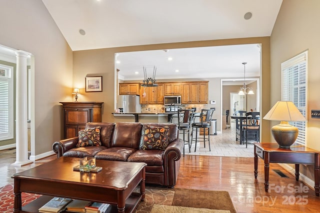 7612 Maple Bluff Ln, Concord, NC 28025 - living room featuring decorative columns, light wood finished floors, recessed lighting, and vaulted ceiling