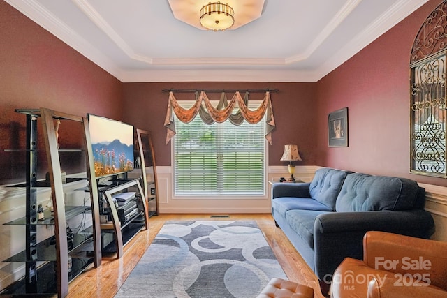 7612 Maple Bluff Ln, Concord, NC 28025 - living room with a tray ceiling, wood finished floors, wainscoting, and ornamental molding