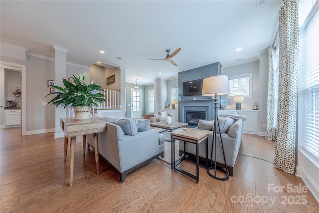 5256 Meadowcroft Way, Fort Mill, SC 29708 - living room with ornamental molding, light wood-type flooring, a ceiling fan, a glass covered fireplace, and recessed lighting