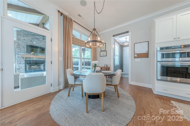 5256 Meadowcroft Way, Fort Mill, SC 29708 - dining space with a chandelier, light wood-style flooring, and crown molding
