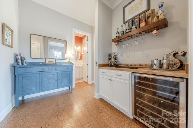 5256 Meadowcroft Way, Fort Mill, SC 29708 - indoor dry bar featuring wine cooler, ornamental molding, and light wood-style flooring