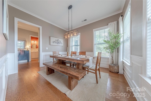5256 Meadowcroft Way, Fort Mill, SC 29708 - dining room featuring a wainscoted wall, light wood-type flooring, a decorative wall, plenty of natural light, and ornamental molding
