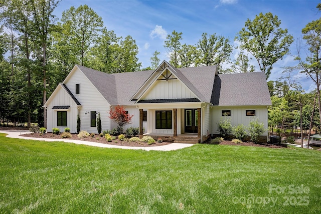 176 Windwood Ln, Troutman, NC 28166 - modern farmhouse with board and batten siding, a front lawn, and a shingled roof