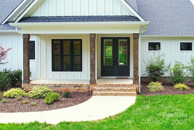 176 Windwood Ln, Troutman, NC 28166 - property entrance featuring board and batten siding, a shingled roof, french doors, and a porch