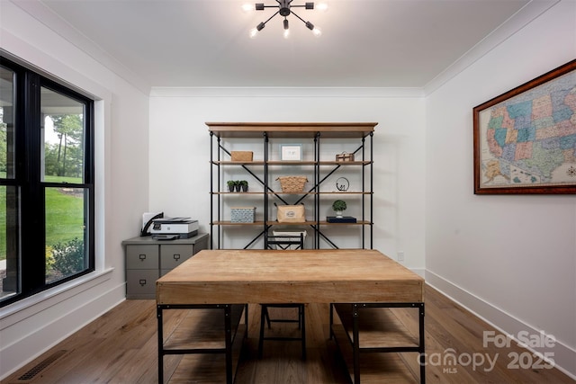 176 Windwood Ln, Troutman, NC 28166 - dining area featuring an office area, wood finished floors, a chandelier, and crown molding