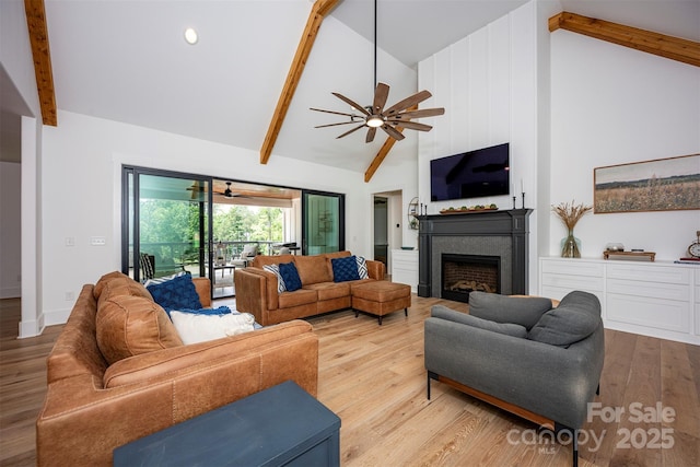 176 Windwood Ln, Troutman, NC 28166 - living room with beam ceiling, a fireplace, wood finished floors, a ceiling fan, and high vaulted ceiling