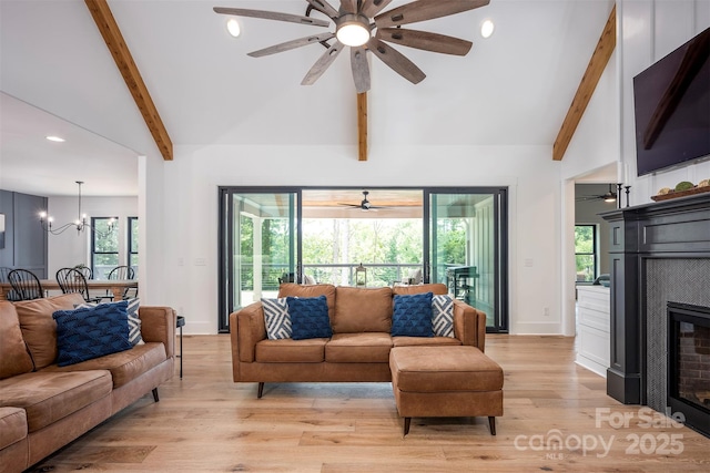 176 Windwood Ln, Troutman, NC 28166 - living room featuring a glass covered fireplace, a ceiling fan, light wood-style flooring, recessed lighting, and healthy amount of natural light