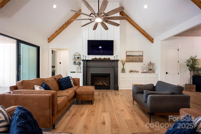 176 Windwood Ln, Troutman, NC 28166 - living room with high vaulted ceiling, beamed ceiling, a ceiling fan, light wood-style floors, and a fireplace