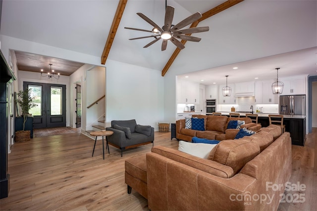 176 Windwood Ln, Troutman, NC 28166 - living room featuring a chandelier, beamed ceiling, recessed lighting, light wood-style flooring, and stairs