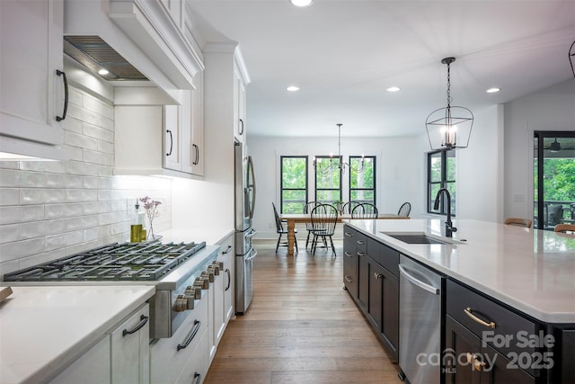 176 Windwood Ln, Troutman, NC 28166 - kitchen featuring appliances with stainless steel finishes, healthy amount of natural light, white cabinetry, and recessed lighting