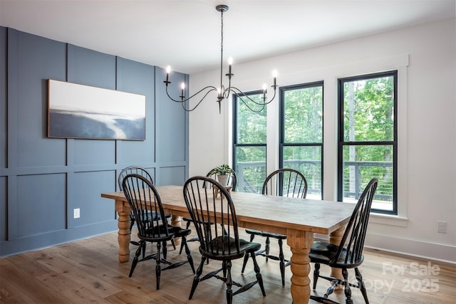 176 Windwood Ln, Troutman, NC 28166 - dining space featuring a decorative wall, light wood-type flooring, plenty of natural light, and a chandelier