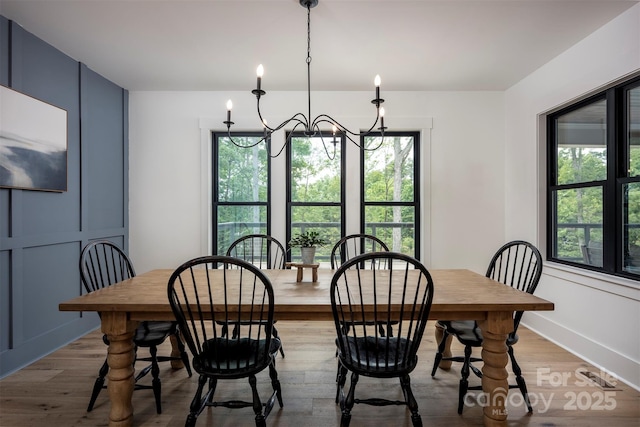 176 Windwood Ln, Troutman, NC 28166 - dining area featuring healthy amount of natural light, wood finished floors, and a chandelier