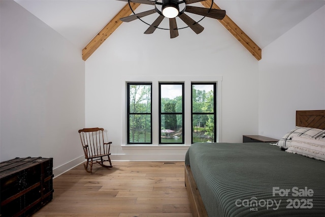 176 Windwood Ln, Troutman, NC 28166 - bedroom with beamed ceiling, high vaulted ceiling, and wood finished floors