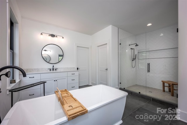 176 Windwood Ln, Troutman, NC 28166 - full bathroom featuring a shower stall, vanity, a freestanding bath, tile patterned floors, and recessed lighting