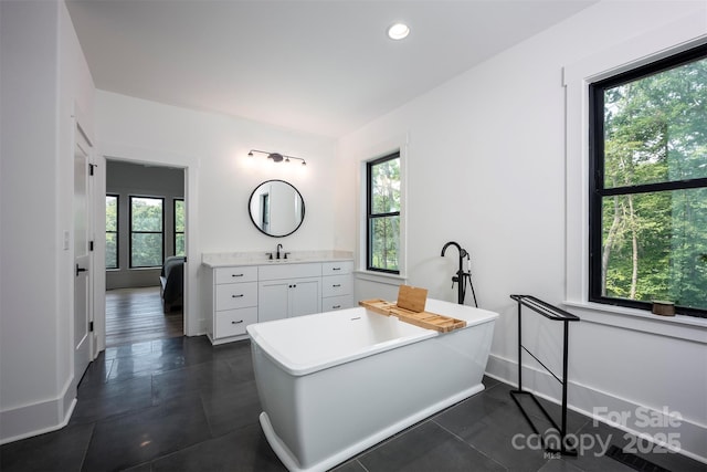 176 Windwood Ln, Troutman, NC 28166 - full bath with vanity, a freestanding bath, tile patterned flooring, and recessed lighting