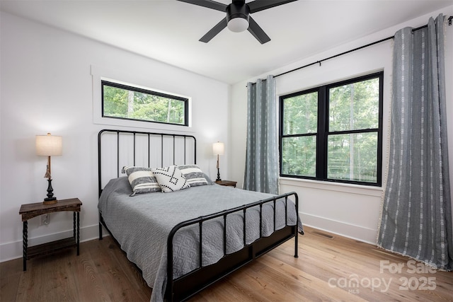 176 Windwood Ln, Troutman, NC 28166 - bedroom featuring multiple windows, wood finished floors, and a ceiling fan