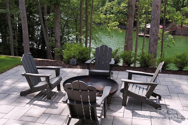 176 Windwood Ln, Troutman, NC 28166 - view of patio with a water view and a fire pit