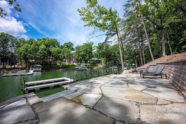 176 Windwood Ln, Troutman, NC 28166 - view of patio with a floating dock, a water view, and view of wooded area