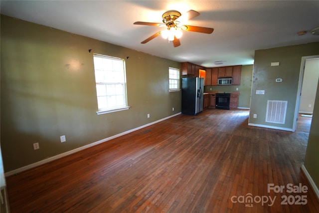 201 W 19th St, Kannapolis, NC 28081 - unfurnished living room with dark wood finished floors and a ceiling fan