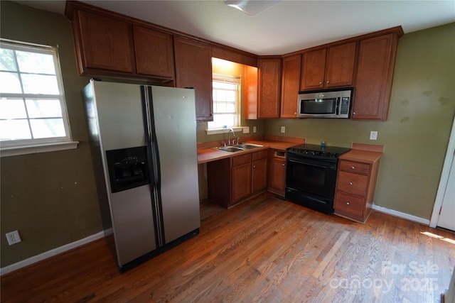 201 W 19th St, Kannapolis, NC 28081 - kitchen featuring stainless steel appliances, light wood-type flooring, brown cabinets, and light countertops