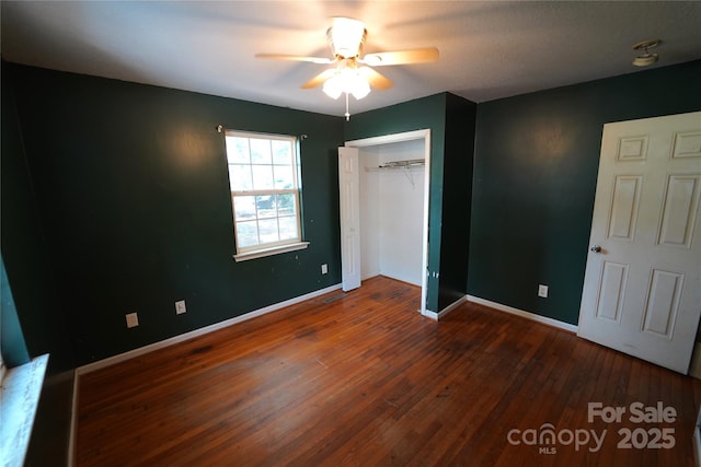 201 W 19th St, Kannapolis, NC 28081 - unfurnished bedroom with hardwood / wood-style flooring, a closet, and a ceiling fan
