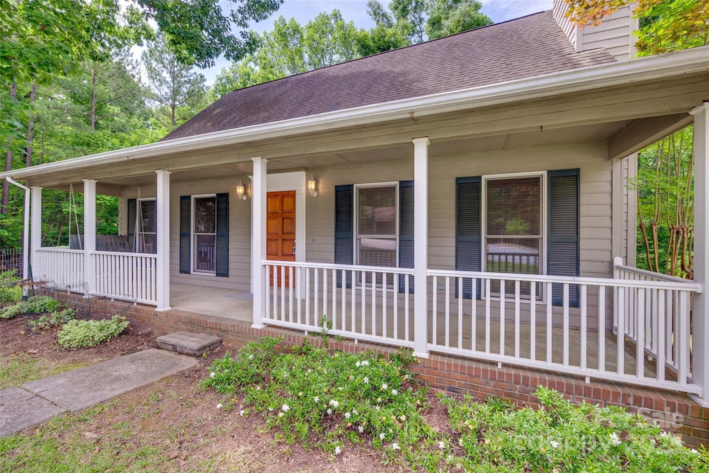 25056 Timberlake Dr, Fort Mill, SC 29708 - view of front facade with covered porch, a chimney, and roof with shingles