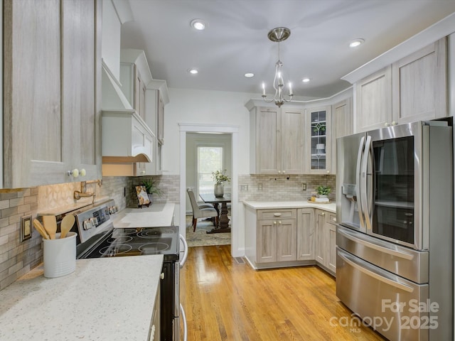 8508 Sandowne Ln, Huntersville, NC 28078 - kitchen featuring appliances with stainless steel finishes, decorative backsplash, glass insert cabinets, a chandelier, and recessed lighting