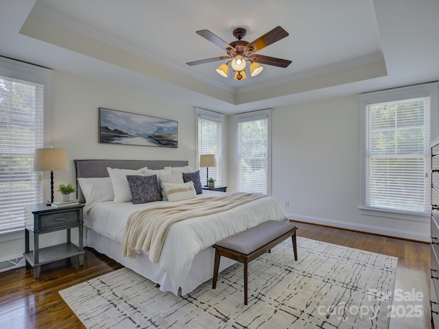 8508 Sandowne Ln, Huntersville, NC 28078 - bedroom with a tray ceiling, dark wood-style floors, ornamental molding, and a ceiling fan