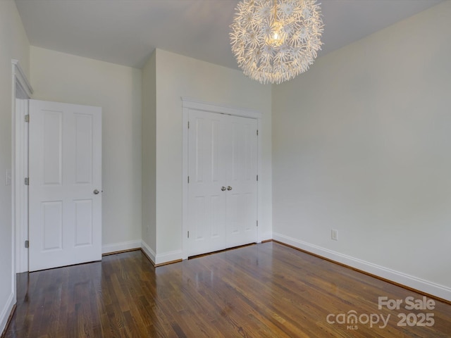 8508 Sandowne Ln, Huntersville, NC 28078 - unfurnished bedroom with a chandelier, wood finished floors, and a closet